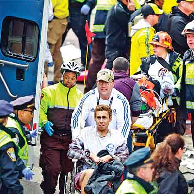 Medical workers aid injured people at the finish line of the 2013 Boston Marathon following an explosion in Boston, on Monday.