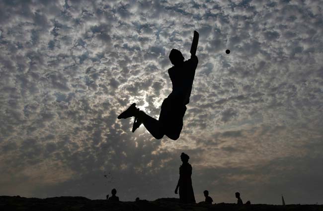 Boys play cricket on the Marina beach in the southern Indian city of Chennai.