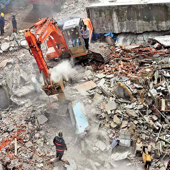 Firemen look for victims in the debris of the Piyush Co-operative housing society building in Dahisar (East). 