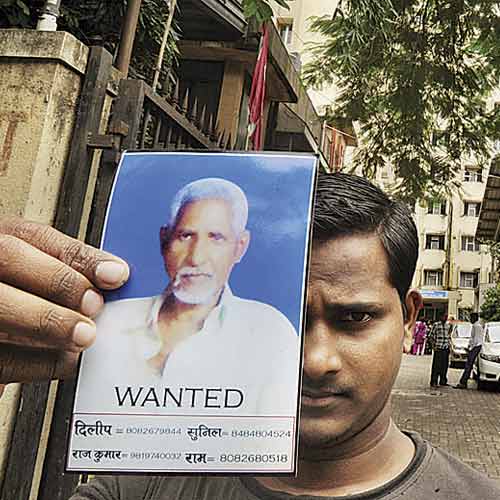 Dilip Kevad shows his father's photo outside Bhabha Hospital in Bandra.