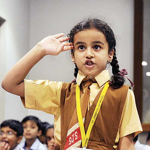 A student salutes while participating in a poetry competition at Mani Bhavan.