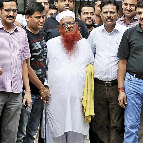 Police officials with Abdul Karim Tunda (C) outside a police station in New Delhi.