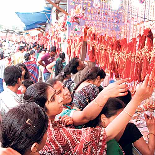 People purchasing rakhis in a market at Sanjay Setu on Sunday.