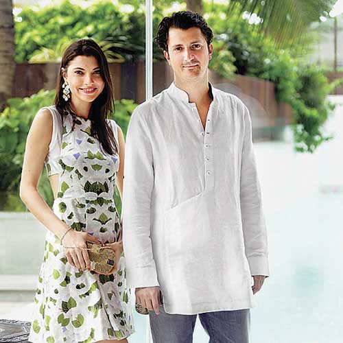 Corto Moltedo poses with a model carrying a clutch from his fall line.