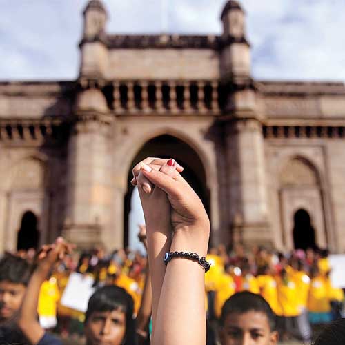 About 500 students of Door Step School form a chain at the Gateway of India to mark Teacher's Day and World Literacy Day on Thursday.