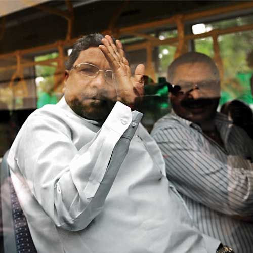 Siddaramaiah waves as he leaves to inspect infrastructure projects currently underway in Bangalore on Saturday.