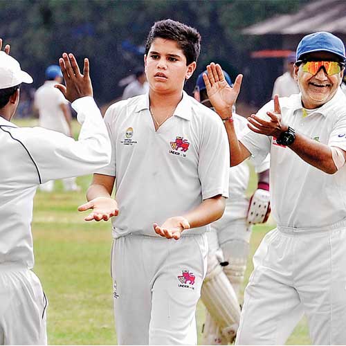 Arjun Tendulkar (centre) celebrates his maiden wicket in the Kanga League on Sunday.