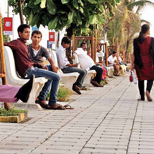 People rest on benches at Worli sea face on Sunday.