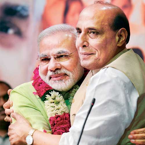 BJP president Rajnath Singh congratulates Narendra Modi after announcing his elevation.