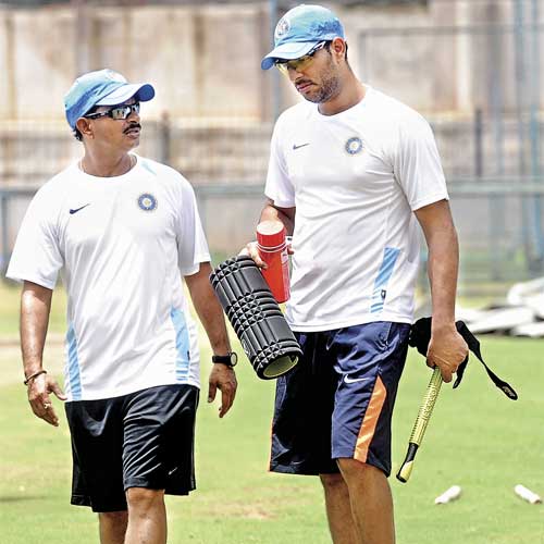 India 'A' coach Lalchand Rajput and skipper Yuvraj Singh during a training session in Bangalore on Wednesday.