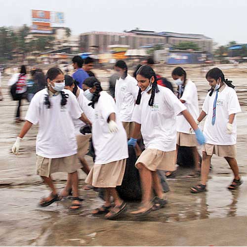 Volunteers clear up Juhu beach on Thursday as part of dna's beach clean-up campaign.