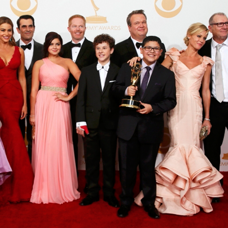 The cast of ABC's series <i>Modern Family</i> poses backstage with their award for Outstanding Comedy Series at the 65th Primetime Emmy Awards in Los Angeles.
