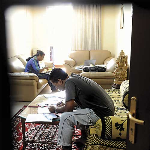 Lokayuktha sleuths examine documents at KAIDB official Omkaramurthy's apartment near Gorgunte Palya in Bangalore on Thursday.