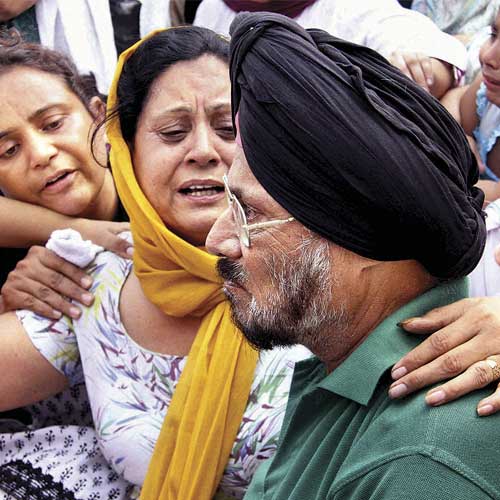 Relatives console the parents of Lt Col Bikramjeet Singh during his cremation in Chandigarh. Singh was killed in the attack on the army unit in Samba.
