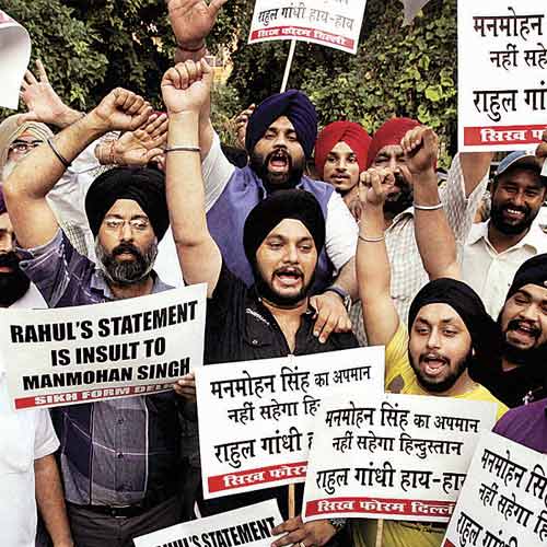 Members of a Sikh forum protest against Rahul Gandhi's view on the controversial ordinance related to convicted lawmakers, in New Delhi on Saturday.