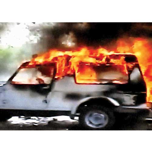 A car burnt during villagers' clash with police on Sunday in a village in Meerut