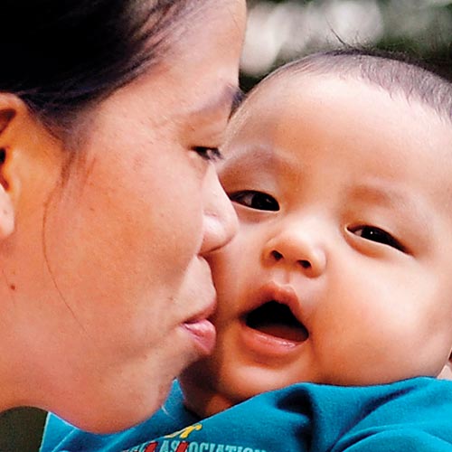 2012 Olympic bronze medallist Mary Kom kisses her son in Mumbai on Monday.