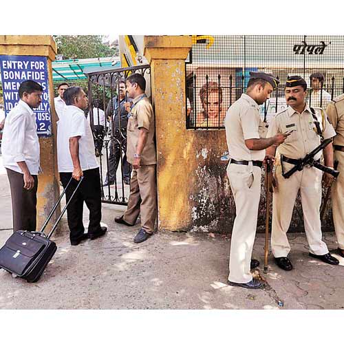 Policemen stand guard as income tax officers enter the Panchratna building in the Opera House area on Thursday.