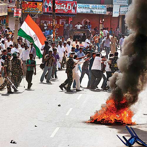 Supporters of united Andhra Pradesh burn barricades and shout slogans during a protest in Ananthapuram.