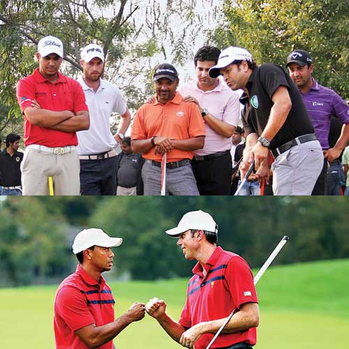 (Below)Tiger Woods and Matt Kuchar of the US team celebrate after a birdie putt on the 13th hole during Day Three four-ball matches at the Muirfield Village Golf Club in Dublin, Ohio, on October 5. (Andy Lyons / Getty Images / AFP)