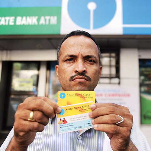 Bharat Kadam displays his debit card