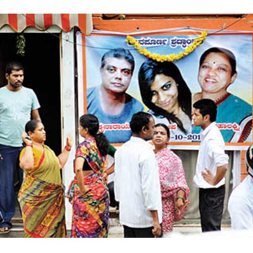 Relatives gather outside the family's house on Wednesday to grieve their loss.