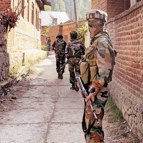 Police and army personnel cordon off the area in south Kashmir's Koil village of Pulwama district after unidentified gunmen fired at the securitymen guarding the houses of Kashmir Pandit on Friday.