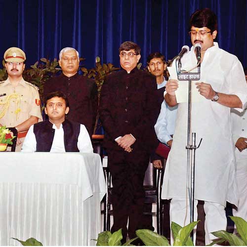 Independent MLA Raghuraj Pratap Singh alias Raja Bhaiya (right) being sworn in as cabinet at Rajbhawan in Lucknow on Friday.