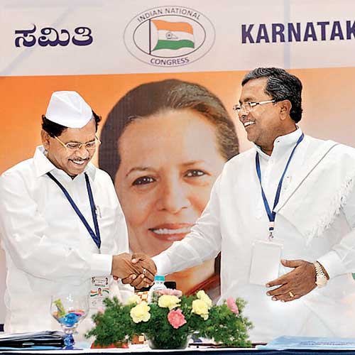 Chief minister Siddaramaiah and KPCC president G Parameshwara greet each other during the Congress's executive committee meeting in Bangalore on Saturday.