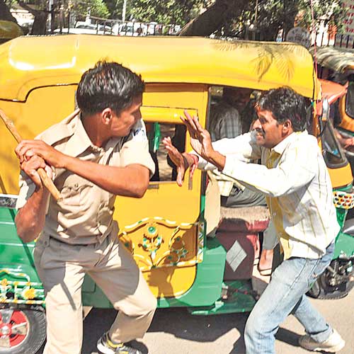 A Congress worker being cane charged by the policeman in front of district court on Tuesday