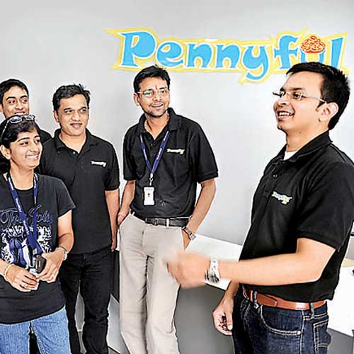Ravitej Yadalam (right), founder and CEO of Pennyful, with his employees in Bangalore on Wednesday.