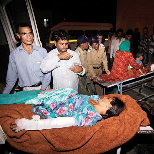 Villagers injured in firing by Pakistani troops are brought on a stretcher for treatment at the government medical college hospital in Jammu.