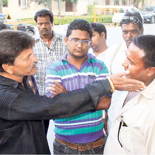 A Bajrang Dal activist threatening the elder brother of the victim's husband near Coffee House on Saturday.