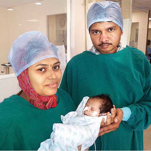 Seemingly happy, the parents hold the infant after the surgery was done last week. The child was suffering from a rare disorder.