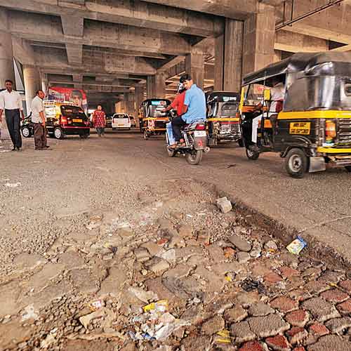 A damaged section of the Andheri-Kurla Road, which runs under a metro station.