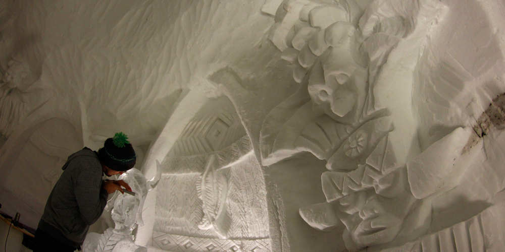 A worker carves ice sculptures for the igloo village on top of the mountain Nebelhorn, alpine upland, near the southern Bavarian town of Oberstdorf December 30, 2013. The Igloo village of 11 igloos which includes a bar igloo, a dining area igloo and an outside whirlpool with 40 degree hot water, is open during the winter months until April. One night costs 114 euros per person, with breakfast and cheese fondue inclusive.