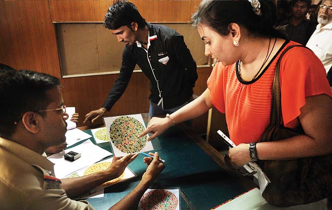 A Tardeo RTO official checks a driving licence applicant to see if she is colour blind or not. Starting Thursday, RTOs started the initiative to curb accidents caused by colour-blind drivers —Hemant Padalkar/dna A Tardeo RTO official checks a driving licence applicant to see if she is colour blind or not. Starting Thursday, RTOs started the initiative to curb accidents caused by colour-blind drivers —Hemant Padalkar/dna