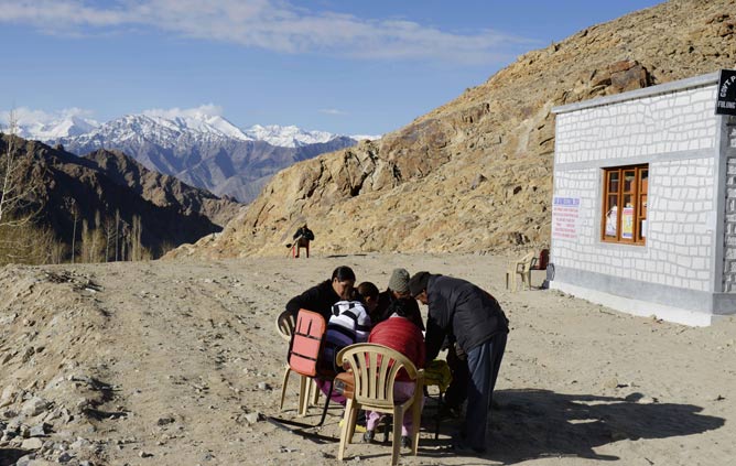 Polling officials and residents look at voting registration lists outside a local polling in the village of Phyang Fulung, in a canyon in the mountainous Indian region of Ladakh near the northern city of Leh on May 7, 2014. More than 95 million voters are eligible to vote in 64 seats in the penultimate leg of the world's biggest general election that ends with results on May 16. AFP PHOTO/Roberto SCHMIDT Polling officials and residents look at voting registration lists outside a local polling in the village of Phyang Fulung, in a canyon in the mountainous Indian region of Ladakh near the northern city of Leh on May 7, 2014. More than 95 million voters are eligible to vote in 64 seats in the penultimate leg of the world's biggest general election that ends with results on May 16. AFP PHOTO/Roberto SCHMIDT
