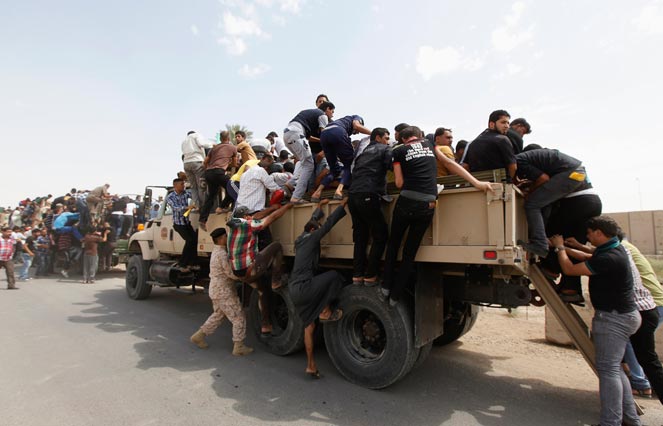 Volunteers who have joined the Iraqi Army to fight against the predominantly Sunni militants, who have taken over Mosul and other Northern provinces, board army trucks in Baghdad, June 13, 2014. Sunni Islamist militants gained more ground in Iraq overnight, moving into two towns in the eastern province of Diyala, while U.S. President Barack Obama considered military strikes to halt their advance towards the capital Baghdad. Militants from the Islamic State in Iraq and the Levant (ISIL) overran the northern city of Mosul earlier this week and have since pressed south towards Baghdad in an onslaught against the Shi'ite-led government. REUTERS/Ahmed Saad Volunteers who have joined the Iraqi Army to fight against the predominantly Sunni militants, who have taken over Mosul and other Northern provinces, board army trucks in Baghdad, June 13, 2014. Sunni Islamist militants gained more ground in Iraq overnight, moving into two towns in the eastern province of Diyala, while U.S. President Barack Obama considered military strikes to halt their advance towards the capital Baghdad. Militants from the Islamic State in Iraq and the Levant (ISIL) overran the northern
