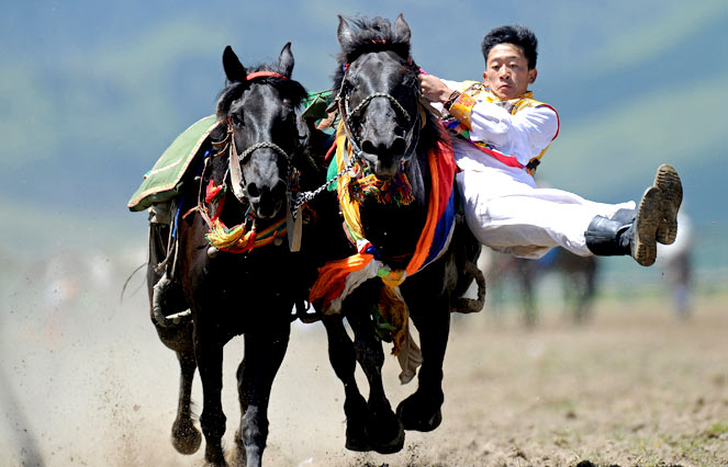 A rider in an ethnic group costume competes in a traditional horseback riding event in Hongyuan county of Aba town, or Ngawa town, southwest China's Sichuan province. Some 300 riders from 15 teams around the country took part in the traditional horseback riding event, local media reported. AFP Photo china