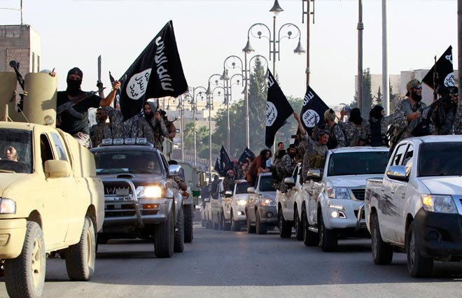 Militant Islamist fighters parade on military vehicles along the streets of northern Raqqa province June 30, 2014. Militant Islamist fighters held a parade in Syria's northern Raqqa province to celebrate their declaration of an Islamic "caliphate" after the group captured territory in neighbouring Iraq, a monitoring service said. The Islamic State, an al Qaeda offshoot previously known as Islamic State in Iraq and the Levant (ISIL), posted pictures online on Sunday of people waving black flags from cars and holding guns in the air, the SITE monitoring service said. REUTERS/Stringer Militant Islamist fighters parade on military vehicles along the streets of northern Raqqa province June 30, 2014. Militant Islamist fighters held a parade in Syria's northern Raqqa province to celebrate their declaration of an Islamic "caliphate" after the group captured territory in neighbouring Iraq, a monitoring service said. The Islamic State, an al Qaeda offshoot previously known as Islamic State in Iraq and the Levant (ISIL), posted pictures online on Sunday of people waving black flags from cars and