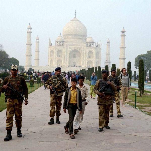 Armed personnel patrol inside the grounds of the Taj Mahal 