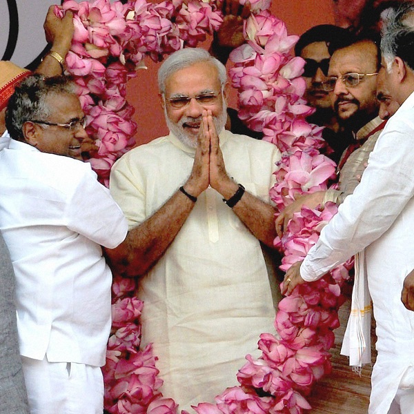 Prime Minister Narendra Modi being garlanded during the Jan Kalyan Rally at Farah in Mathura district on Monday.