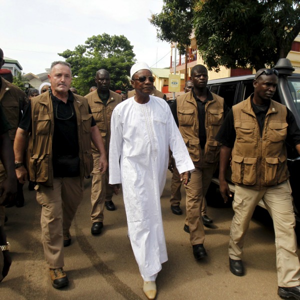 President Alpha Conde leaves a polling station during a presidential election in Conakry, Guinea 