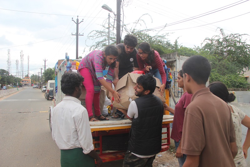 EFI volunteers distribute food and essential items to people