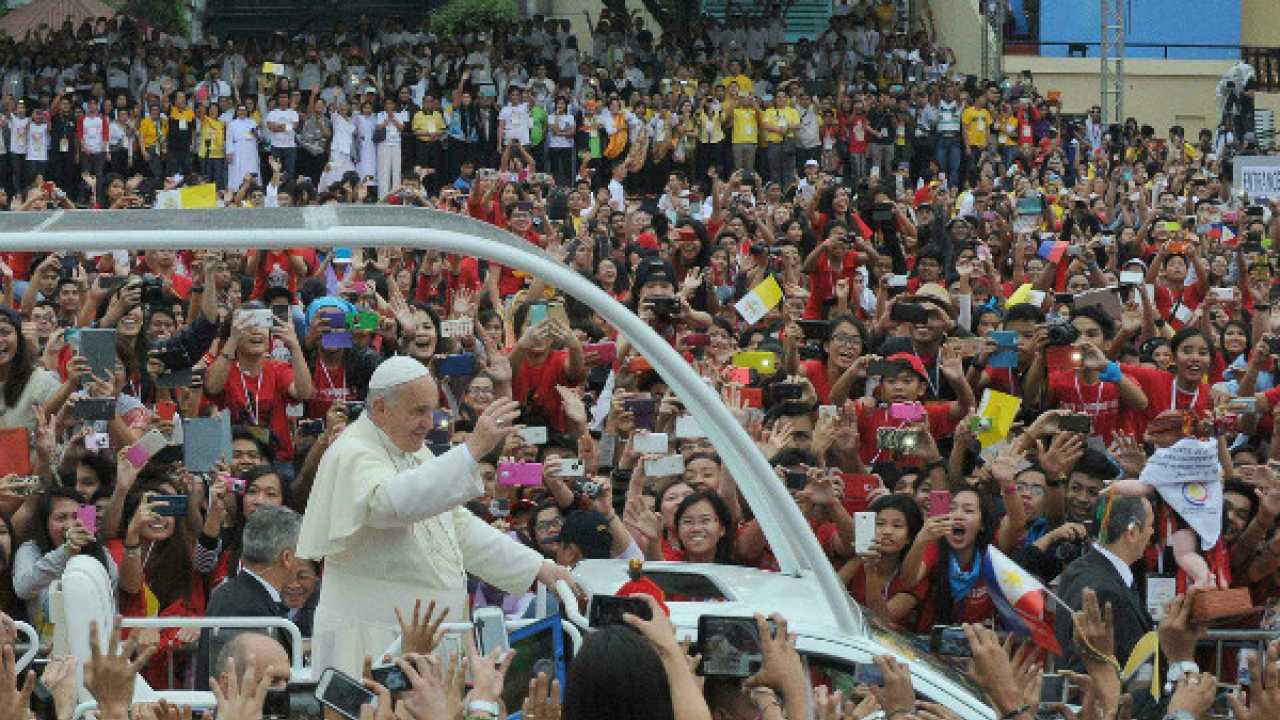 Pope Francis waves as he arrives for a visit to the University of Santo Tomas in Manila on Jan 18, 2015.