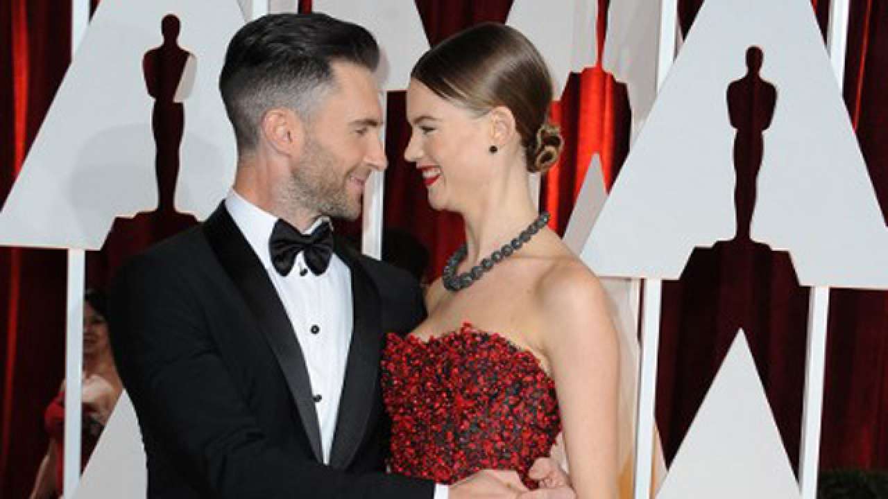 Adam Levine and wife Behati Prinsloo arrive on the red carpet for the 87th Oscars