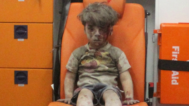 Aleppo: Covered in dust and blood, image of dazed 5-year-old boy captures horrors of Syria war