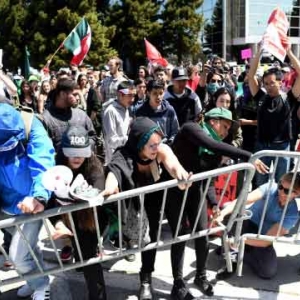 Protesters push over a barricade as they demonstrate against US Republican presidential candidate Donald Trump outside the Hyatt hotel where Trump was speaking at the California GOP convention in Burlingame, California, US, April 29, 2016. Protesters push over a barricade as they demonstrate against US Republican presidential candidate Donald Trump outside the Hyatt