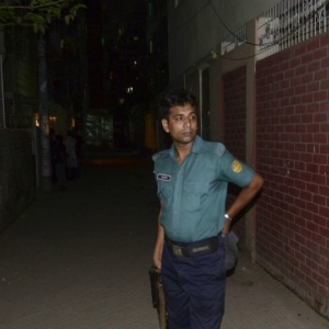 A Bangladeshi police official stands after in front of an apartment in Dhaka on April 25, 2016. where here a leading gay rights activist was allegedly hacked to death. Two people including a leading gay rights activist were hacked to death at an apartment in the Bangladesh capital Dhaka, police said, the latest in a series of attacks on minorities in the Muslim-majority nation. Bangladesh